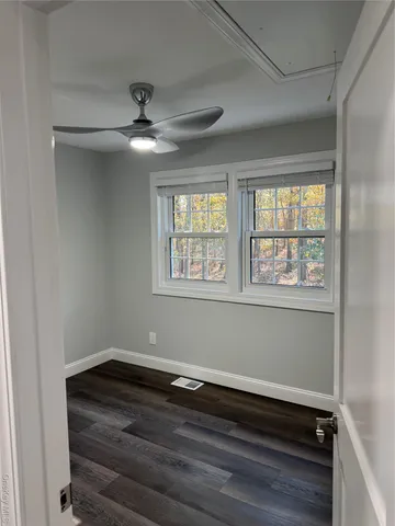 a view of a room with wooden floor and windows