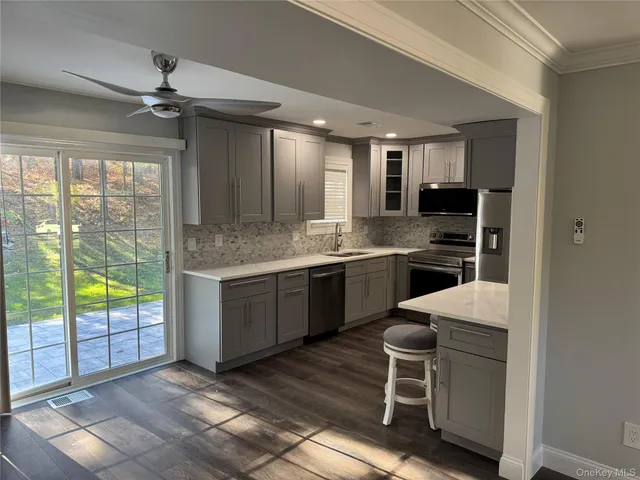 a kitchen with a sink appliances and cabinets