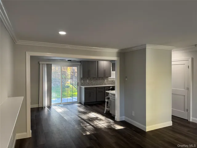 a view of room with window and wooden floor