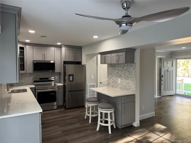 a kitchen with refrigerator cabinets and wooden floor