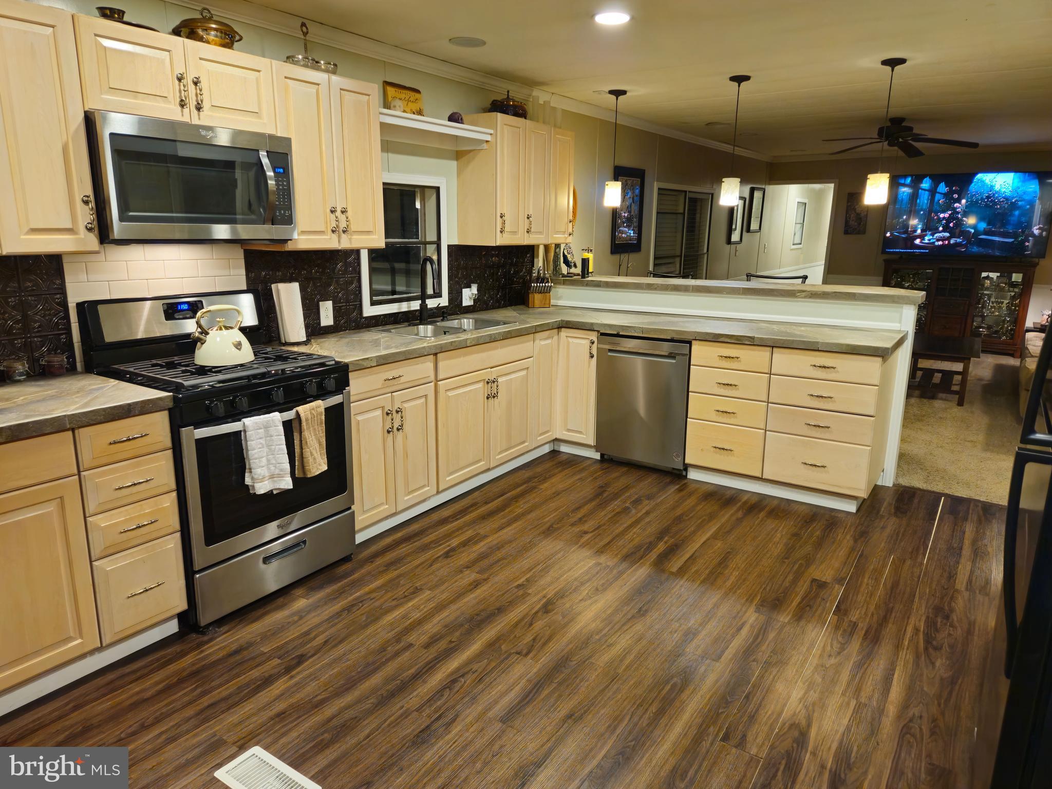 1008 Marticville Road Pequea, PA 17565 - Photo 11 of 27 a kitchen with stainless steel appliances granite countertop a stove a sink and a microwave