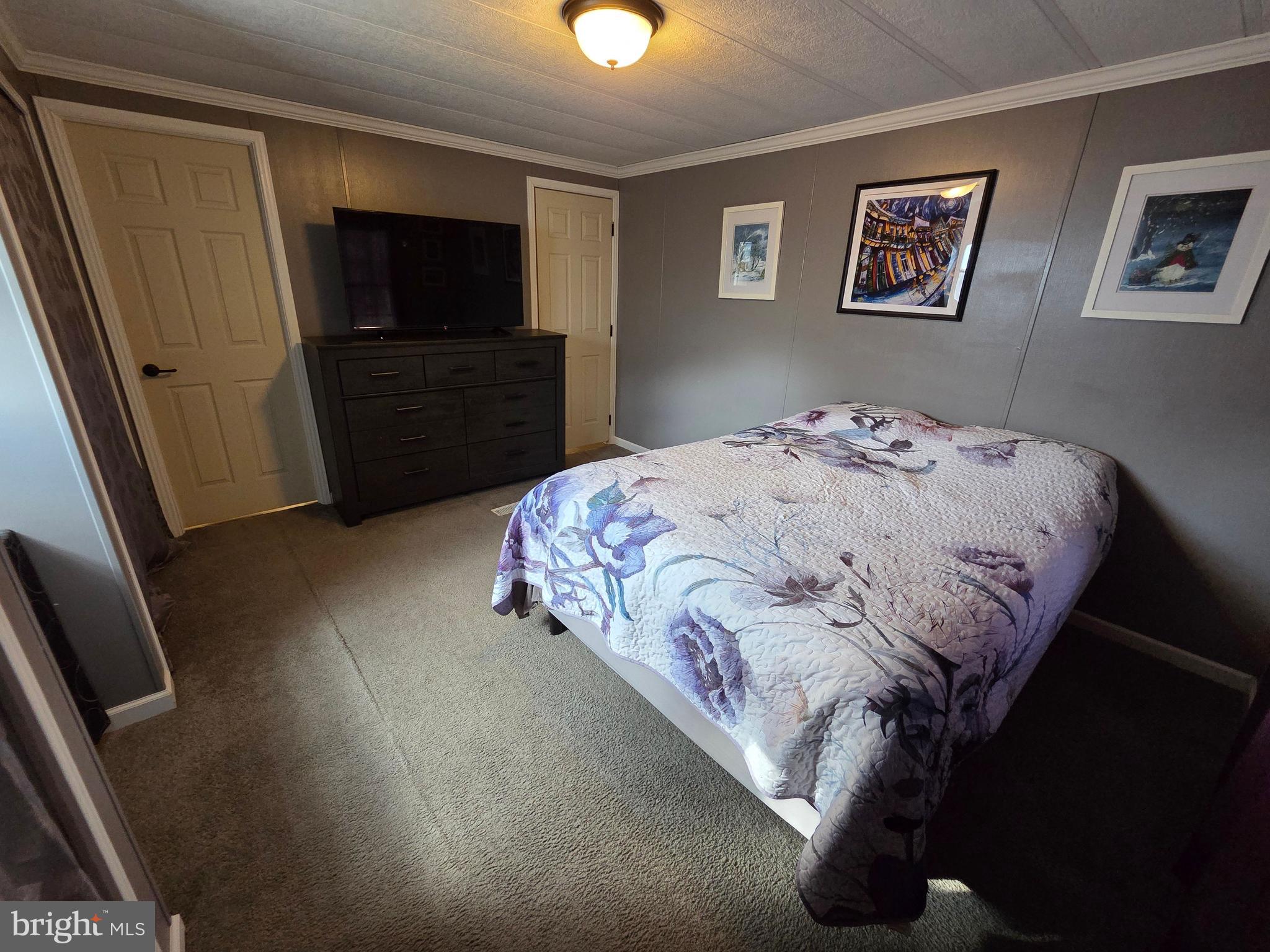 1008 Marticville Road Pequea, PA 17565 - Photo 16 of 27 a bedroom with a bed and a flat screen tv