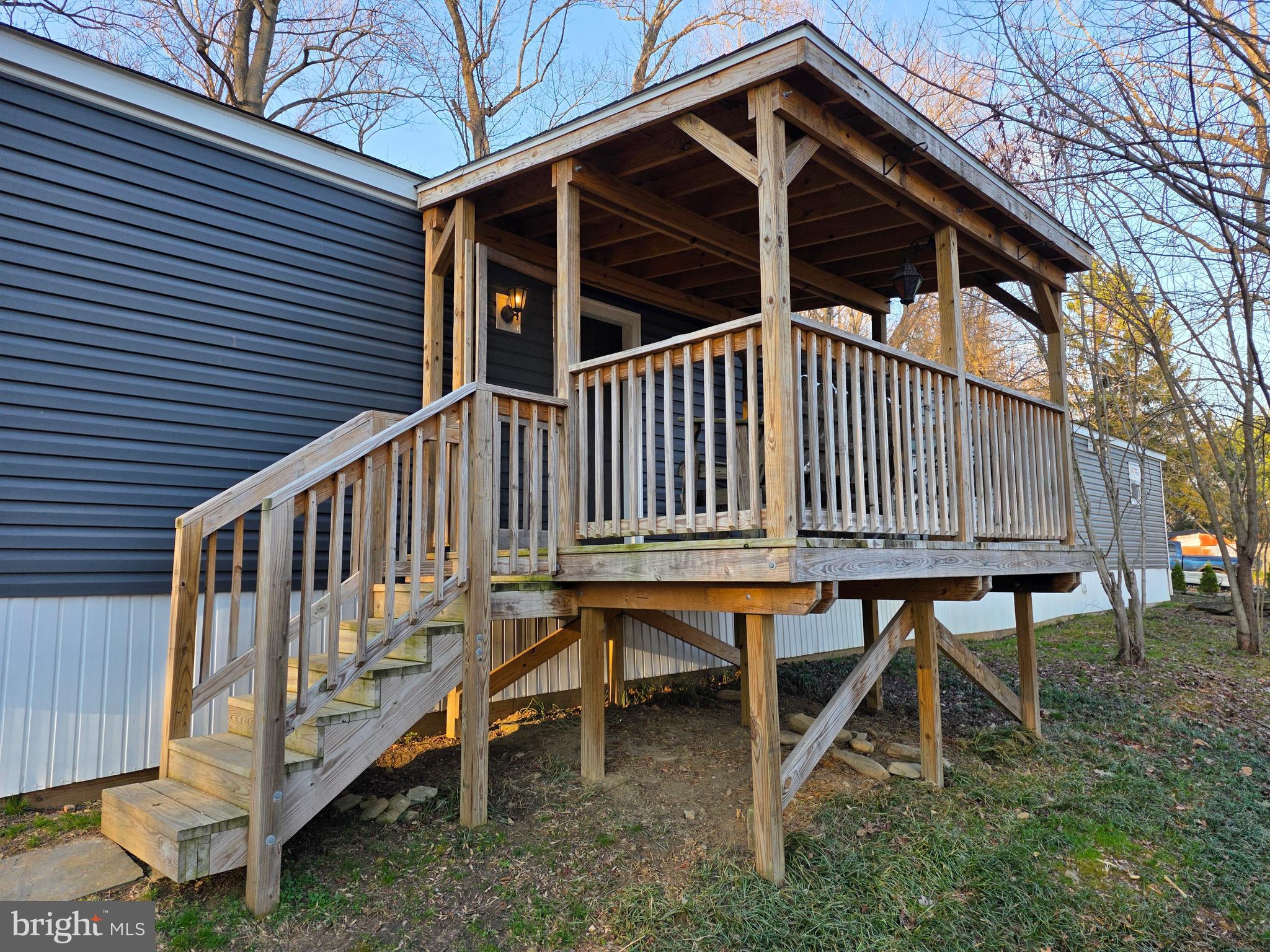 1008 Marticville Road Pequea, PA 17565 - Photo 22 of 27 a view of a house with a wooden deck and a wooden fence