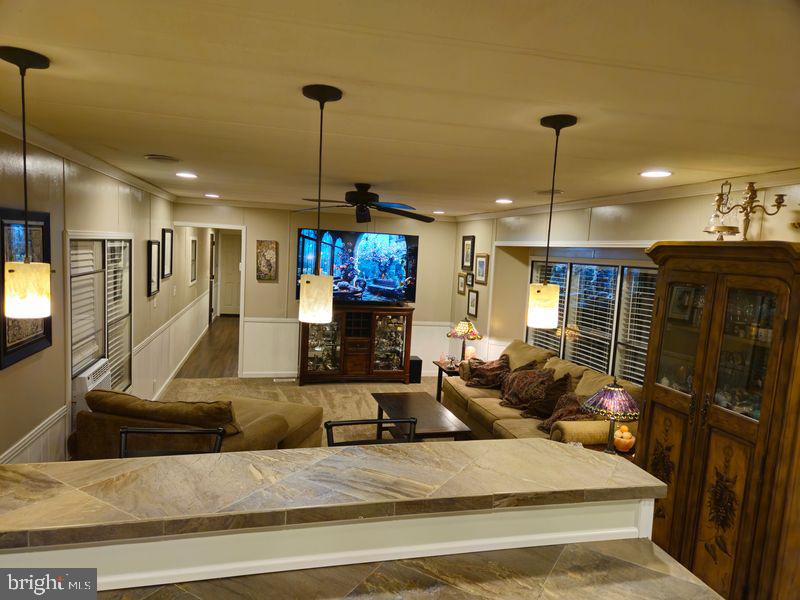 1008 Marticville Road Pequea, PA 17565 - Photo 4 of 27 a large living room with stainless steel appliances granite countertop furniture a fireplace and a flat screen tv