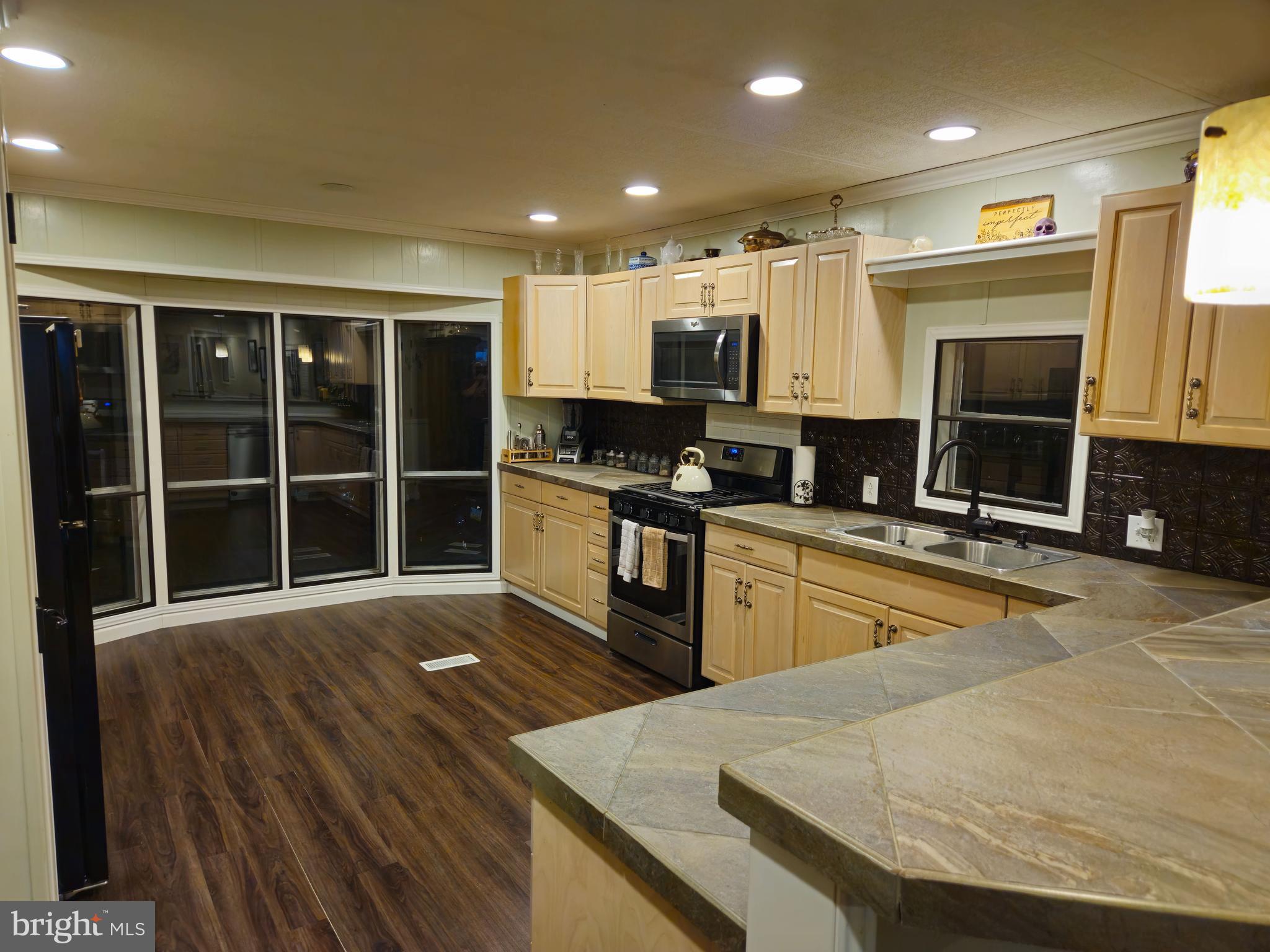 1008 Marticville Road Pequea, PA 17565 - Photo 9 of 27 a kitchen with stainless steel appliances granite countertop a stove a sink and a microwave