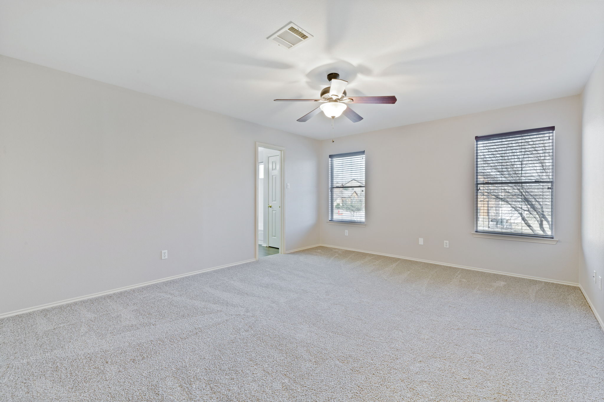 1608 Melibee Trail Austin, TX 78748 - Photo 19 of 29 Empty room with light carpet and ceiling fan