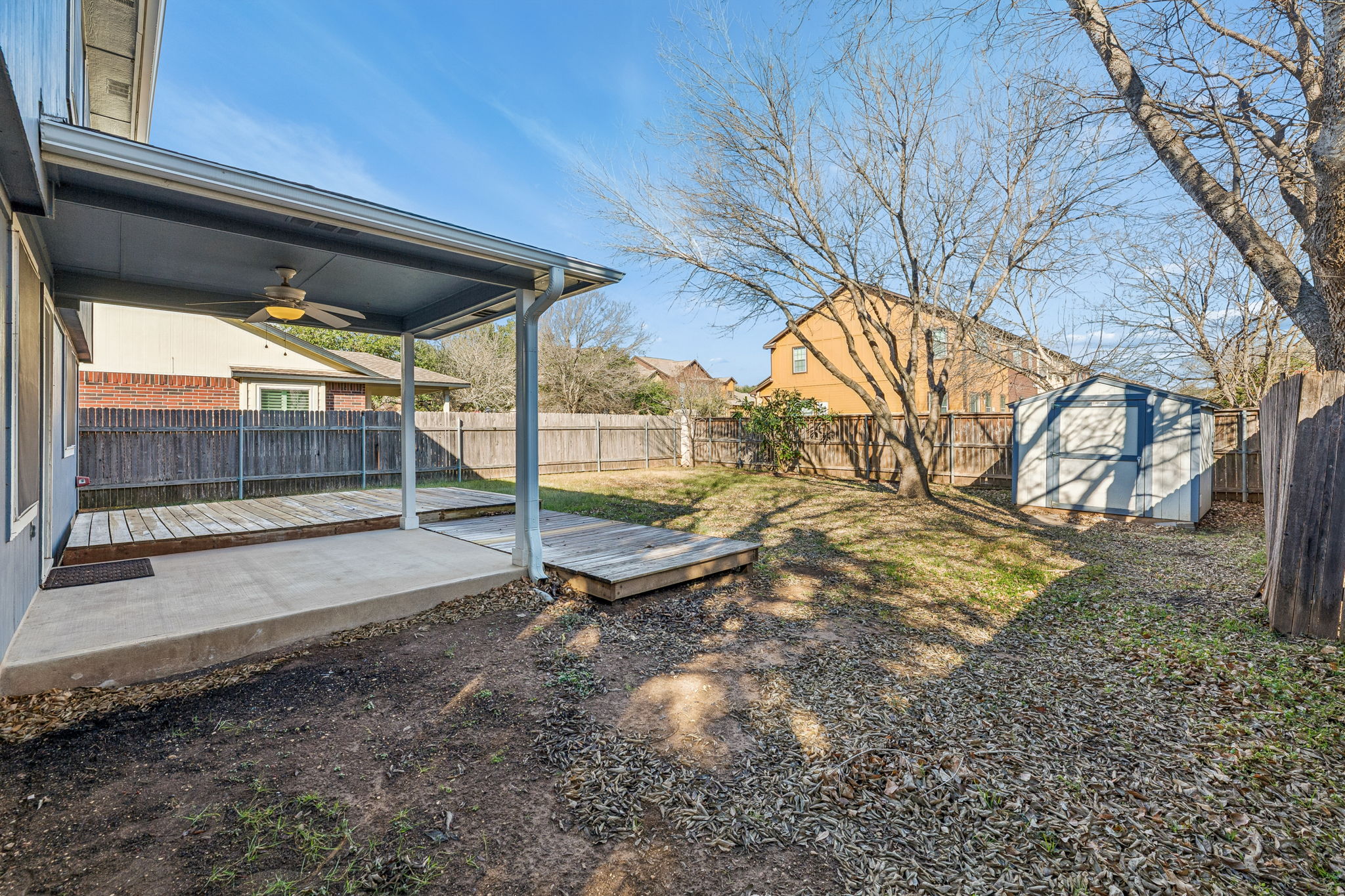 1608 Melibee Trail Austin, TX 78748 - Photo 26 of 29 Fenced backyard featuring ceiling fan, a wooden deck, a storage unit, and a patio area