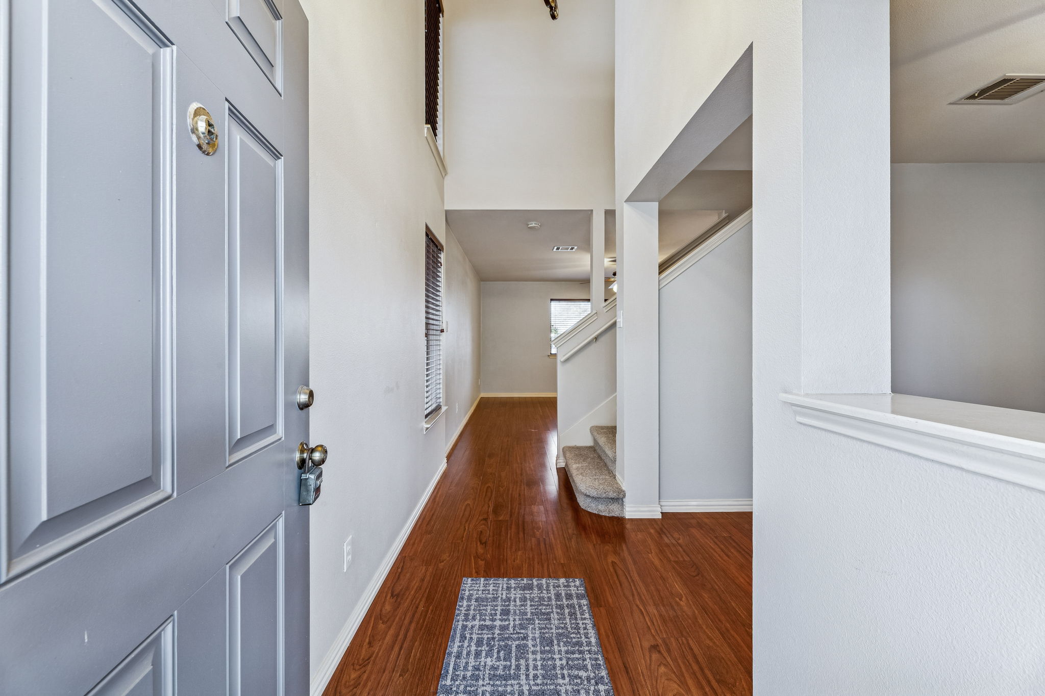 1608 Melibee Trail Austin, TX 78748 - Photo 3 of 29 Foyer entrance with dark wood-style floors and a high ceiling