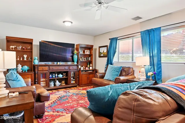 a bedroom with two beds and a flat screen tv