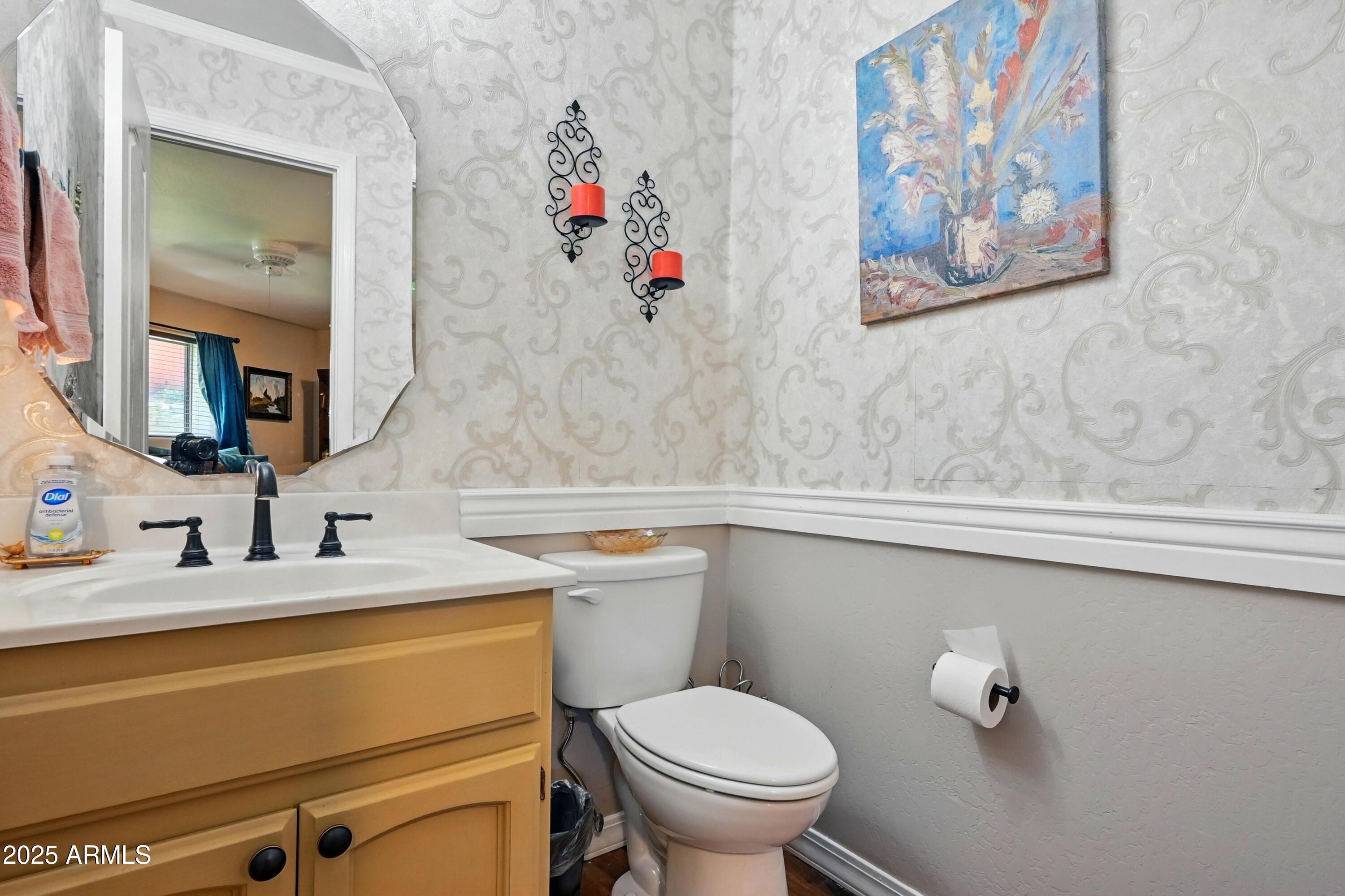 601 East Phoenix Street Payson, AZ 85541 - Photo 15 of 46 a bathroom with a toilet sink and mirror