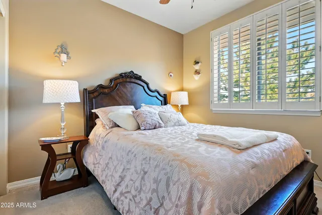 a bedroom with a bed and a lamp