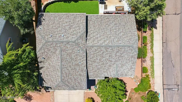 aerial view of a brick house with a yard and potted plants