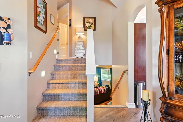 a view of entryway and hall with wooden floor