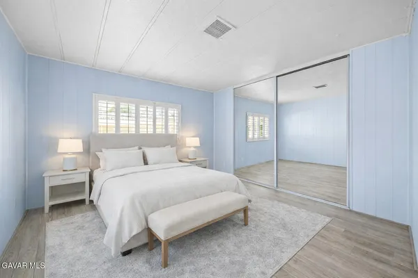 a bedroom with a bed and a walk in closet