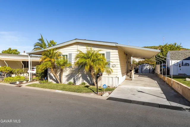 a kitchen with granite countertop a refrigerator stove and sink