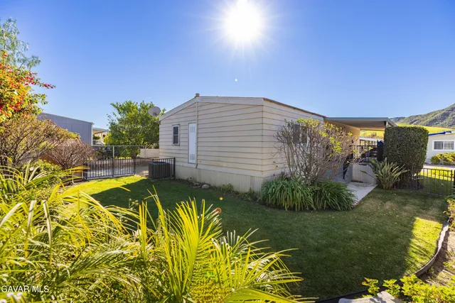 a view of a swimming pool with a yard and sitting area
