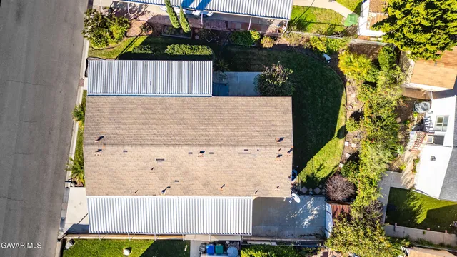 an aerial view of a house with garden space and swimming pool