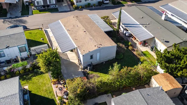 an aerial view of a house with a yard