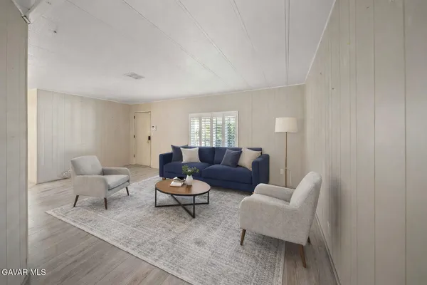 a living room with furniture and a potted plant