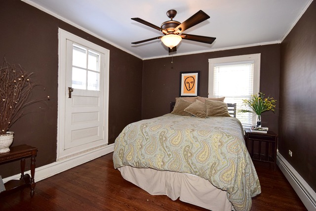 180 Fairbank Road Riverside, IL 60546 - Photo 18 of 25 a bedroom with a bed and a chandelier