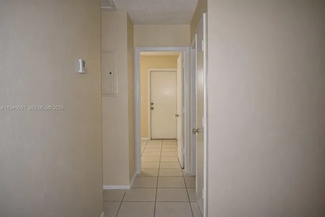 a view of a hallway to rooms
