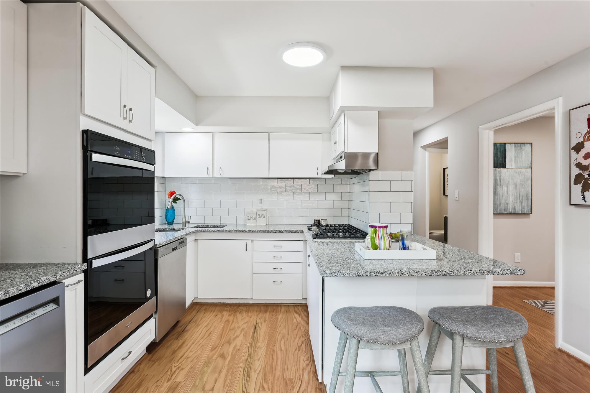 11524 Charlton Drive Silver Spring, MD 20902 - Photo 12 of 64 a kitchen with stainless steel appliances granite countertop a kitchen island hardwood floor sink and stove