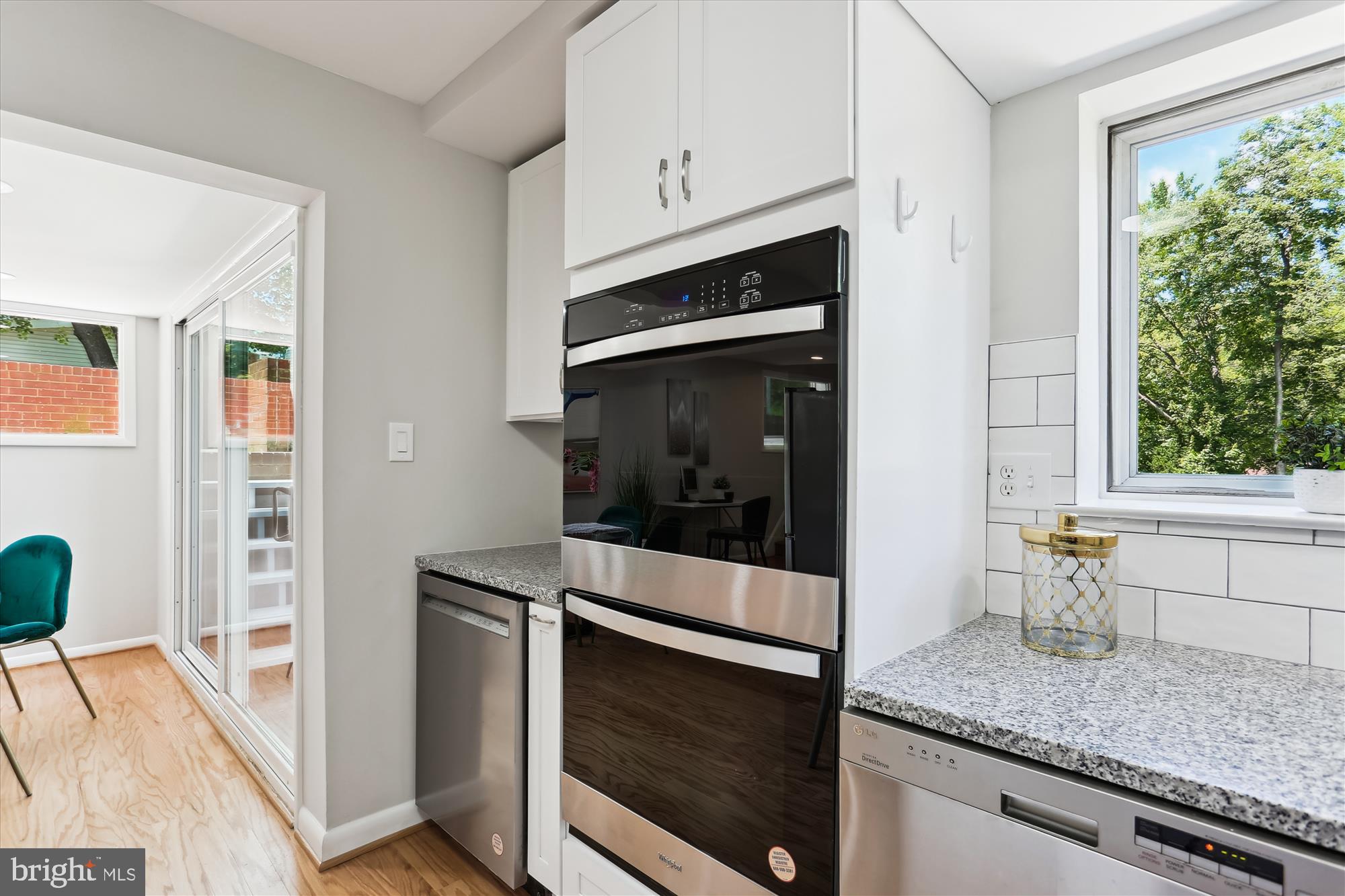 11524 Charlton Drive Silver Spring, MD 20902 - Photo 13 of 64 a kitchen with granite countertop white cabinets and white appliances