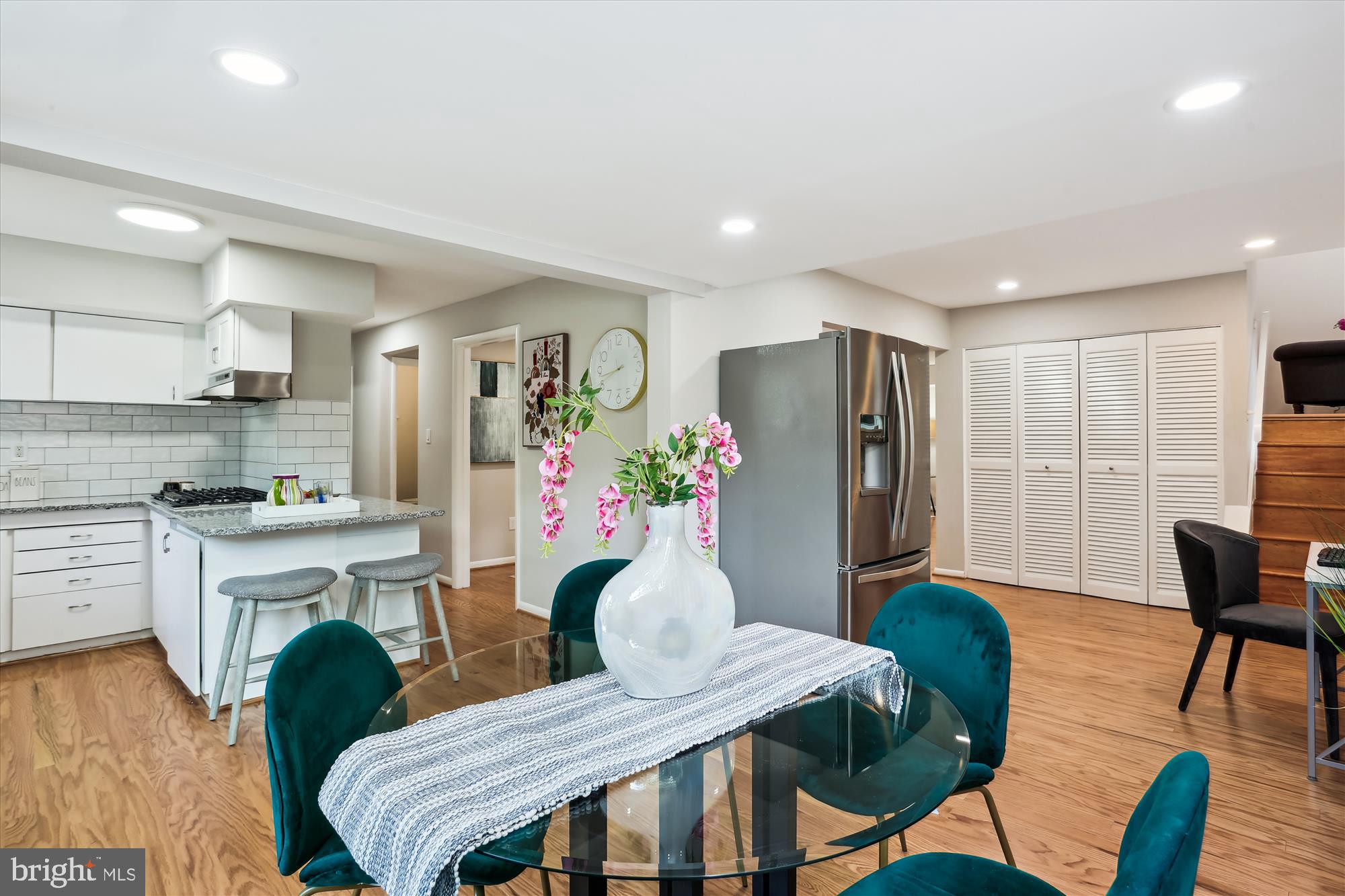11524 Charlton Drive Silver Spring, MD 20902 - Photo 15 of 64 a kitchen with stainless steel appliances granite countertop a kitchen island hardwood floor and a refrigerator