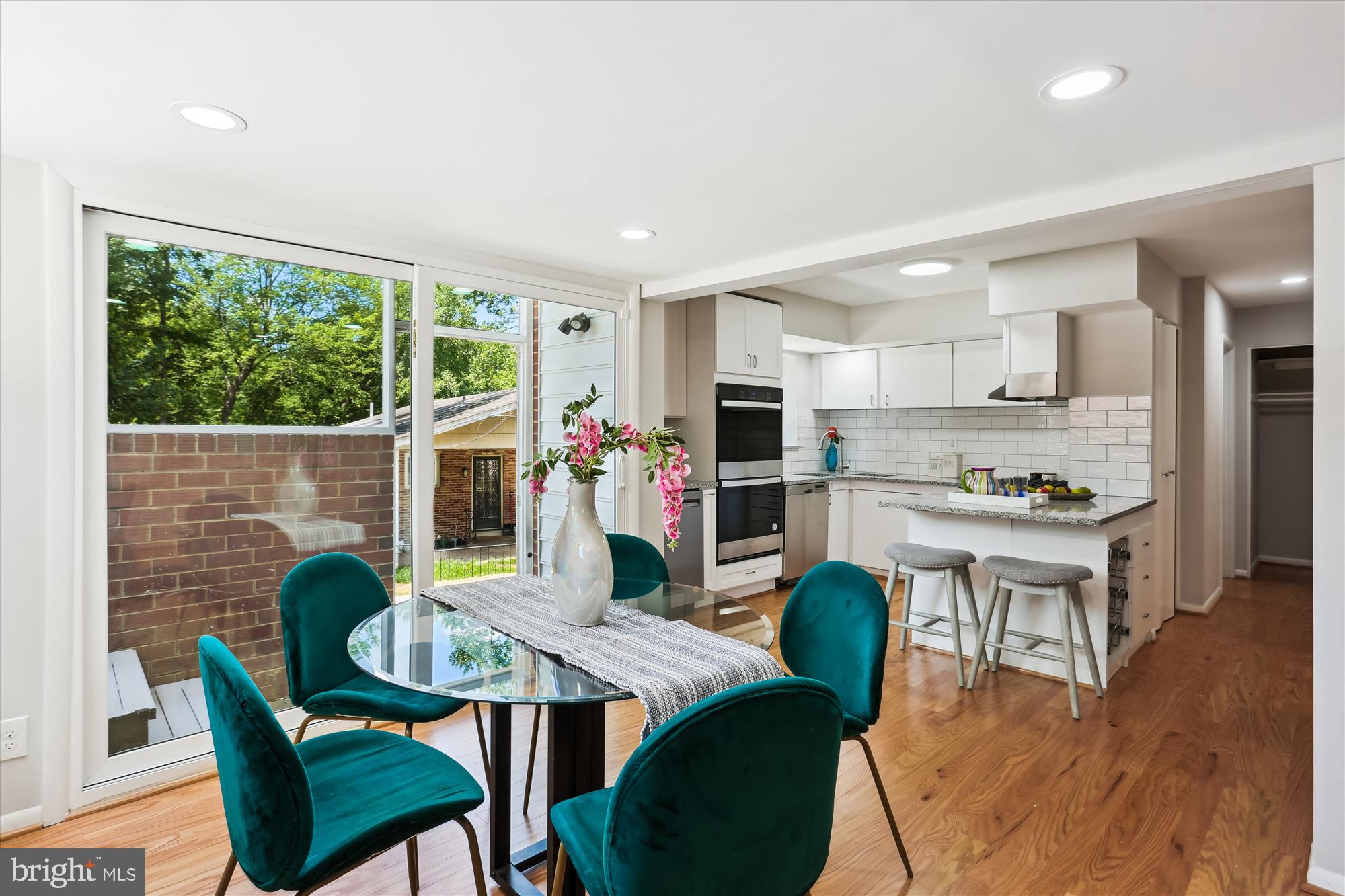 11524 Charlton Drive Silver Spring, MD 20902 - Photo 16 of 64 a view of a dining room with furniture and wooden floor