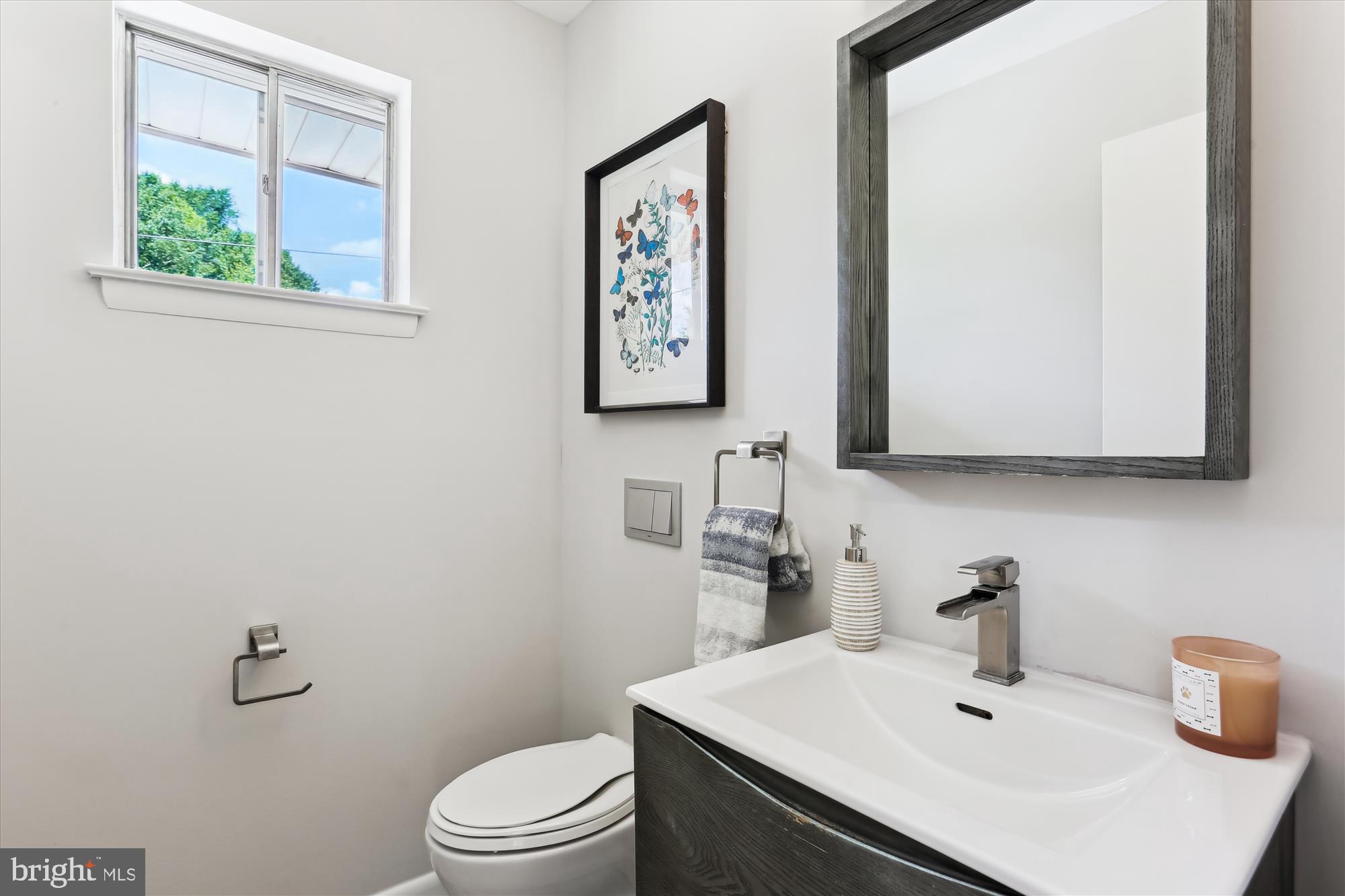 11524 Charlton Drive Silver Spring, MD 20902 - Photo 22 of 64 a bathroom with a sink a toilet and a mirror