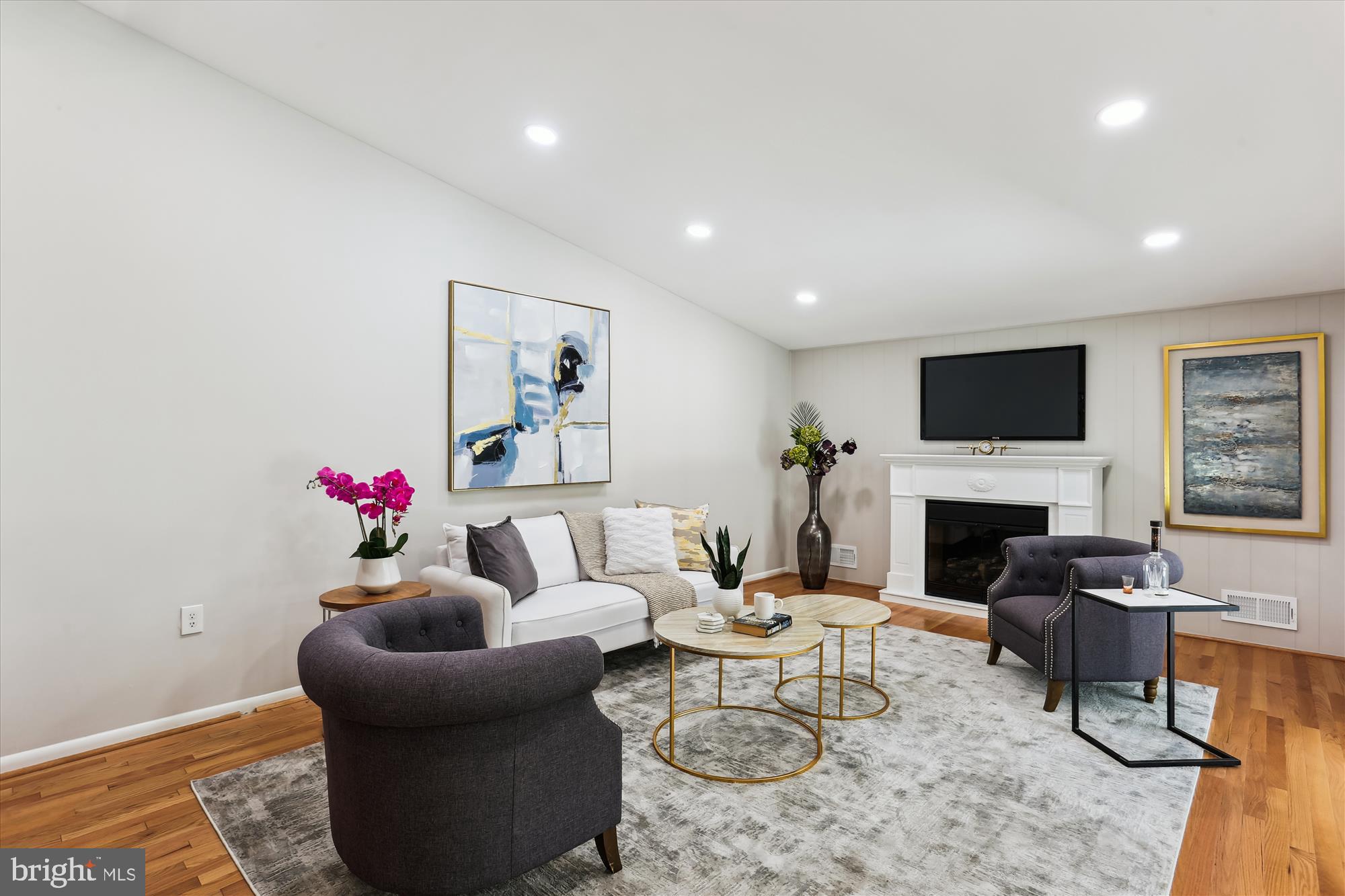 11524 Charlton Drive Silver Spring, MD 20902 - Photo 24 of 64 a living room with furniture a fireplace and a flat screen tv