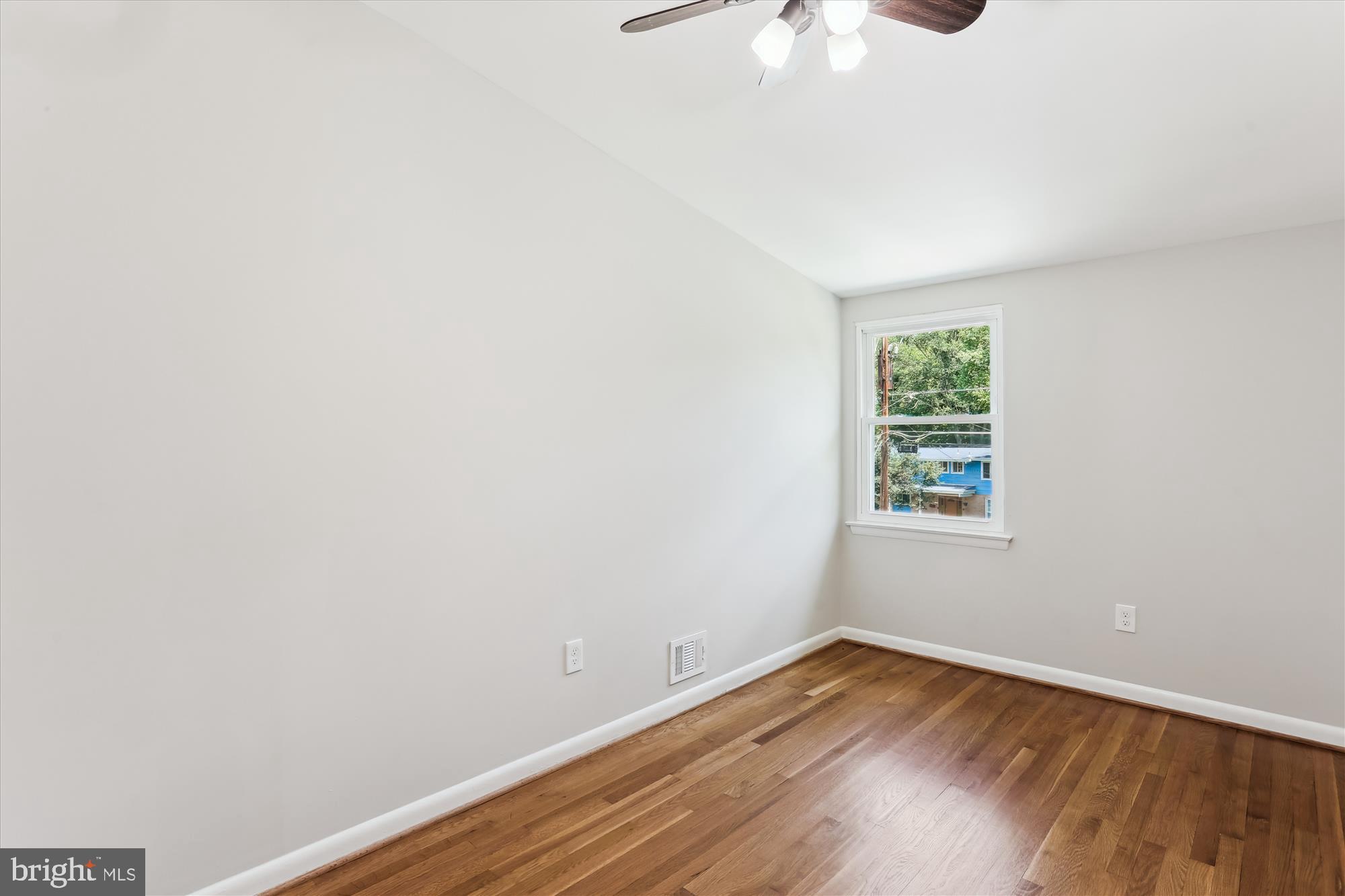 11524 Charlton Drive Silver Spring, MD 20902 - Photo 43 of 64 a view of an empty room with wooden floor and a window