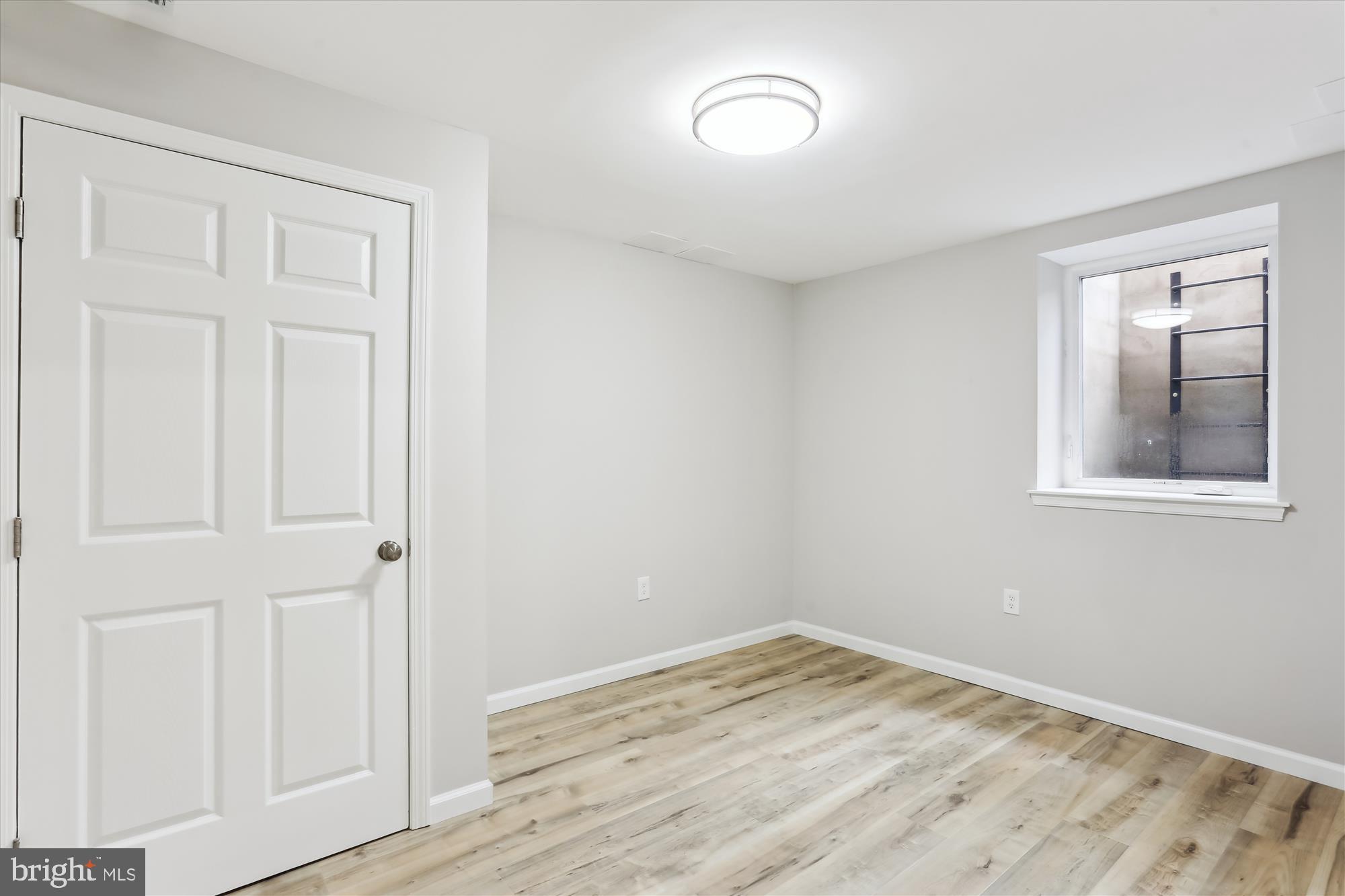 11524 Charlton Drive Silver Spring, MD 20902 - Photo 48 of 64 an empty room with wooden floor and closet
