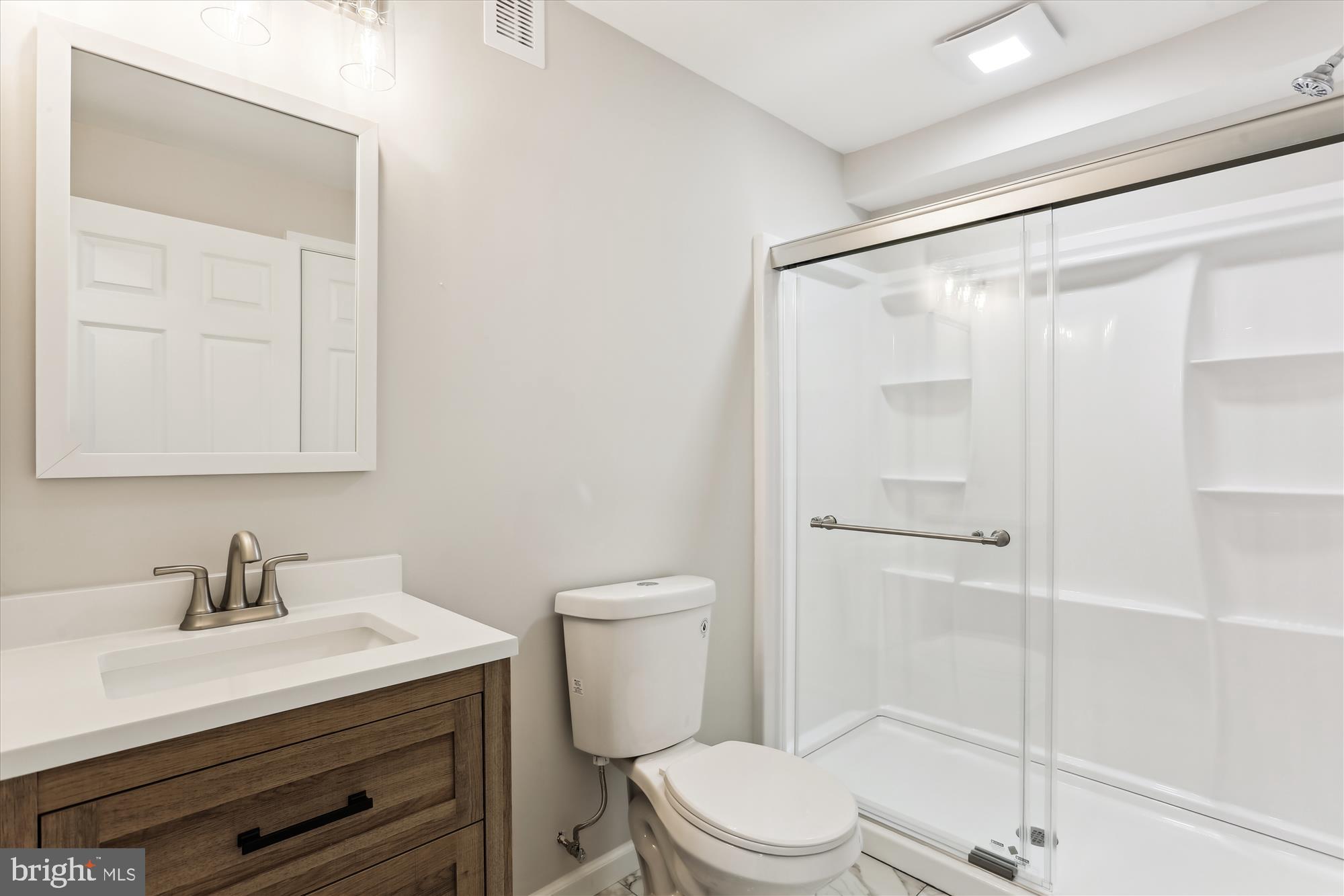 11524 Charlton Drive Silver Spring, MD 20902 - Photo 52 of 64 a bathroom with a sink a mirror and a toilet