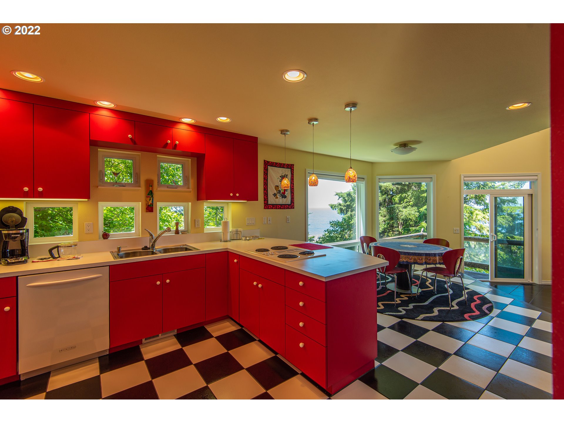 230 Crestview Drive Yachats, OR 97498 - Photo 20 of 31 a kitchen with a sink stove and cabinets