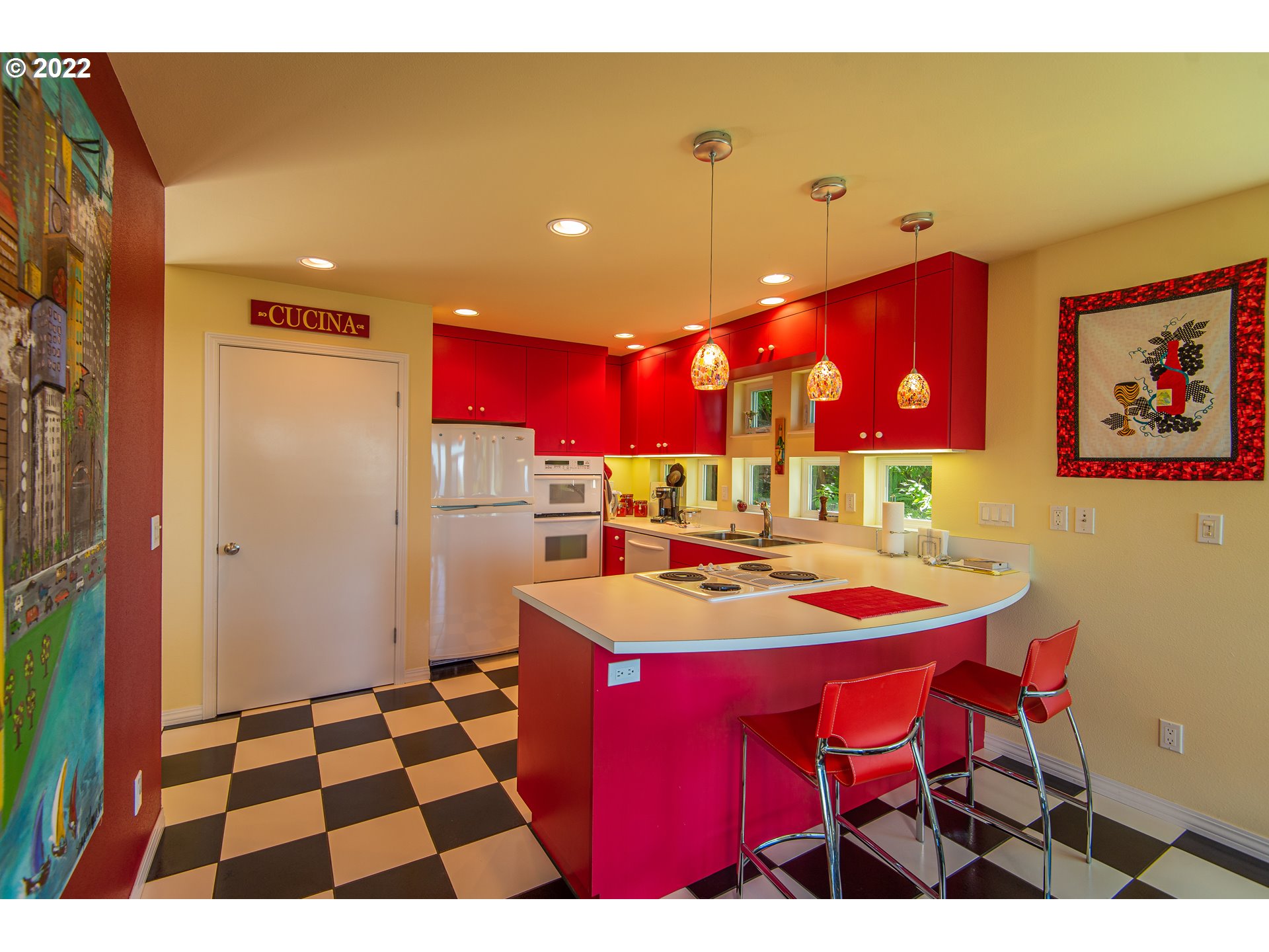 230 Crestview Drive Yachats, OR 97498 - Photo 21 of 31 a kitchen with stainless steel appliances kitchen island granite countertop a dining table and chairs