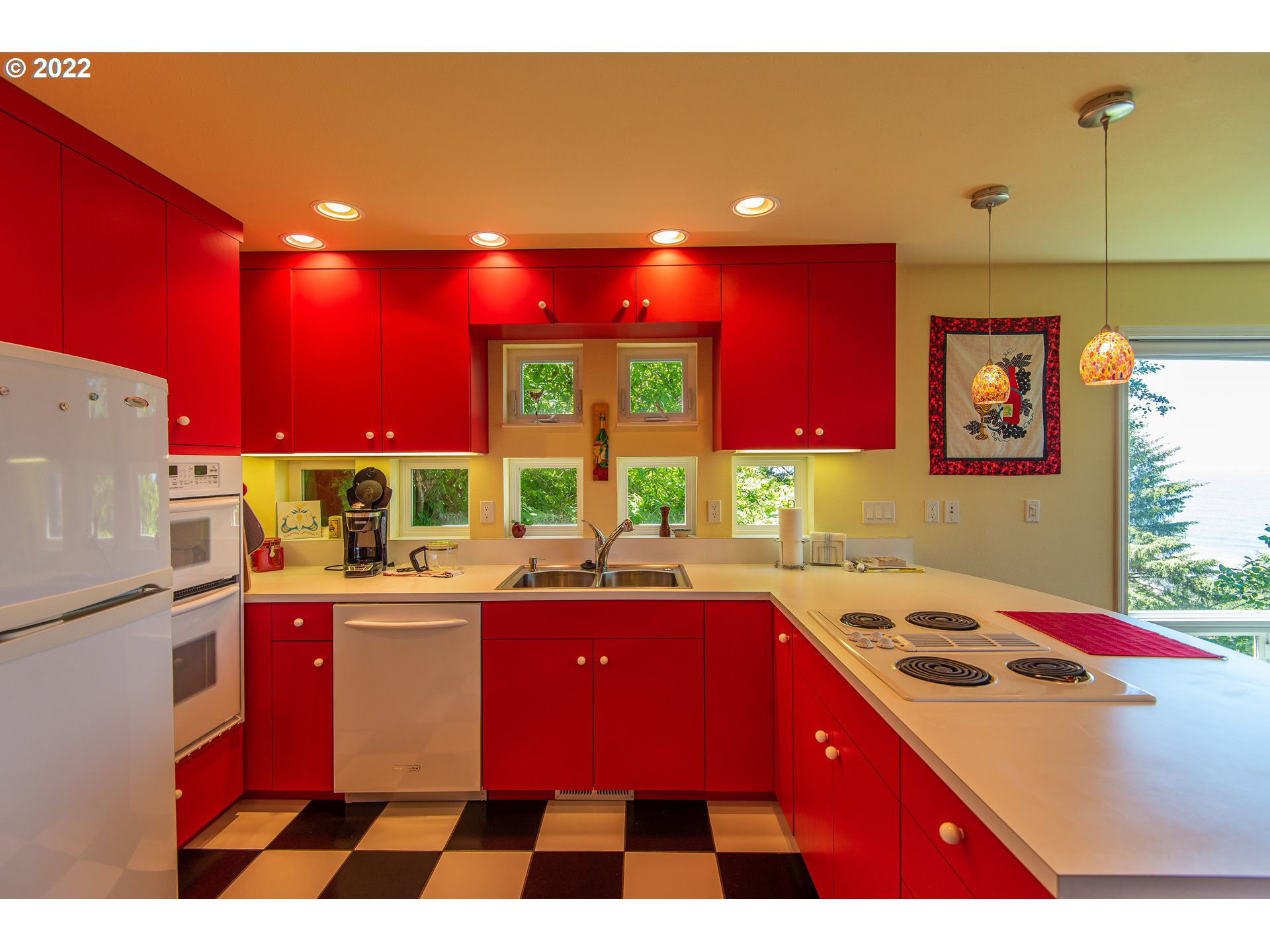 230 Crestview Drive Yachats, OR 97498 - Photo 24 of 31 a kitchen with a sink stove and window