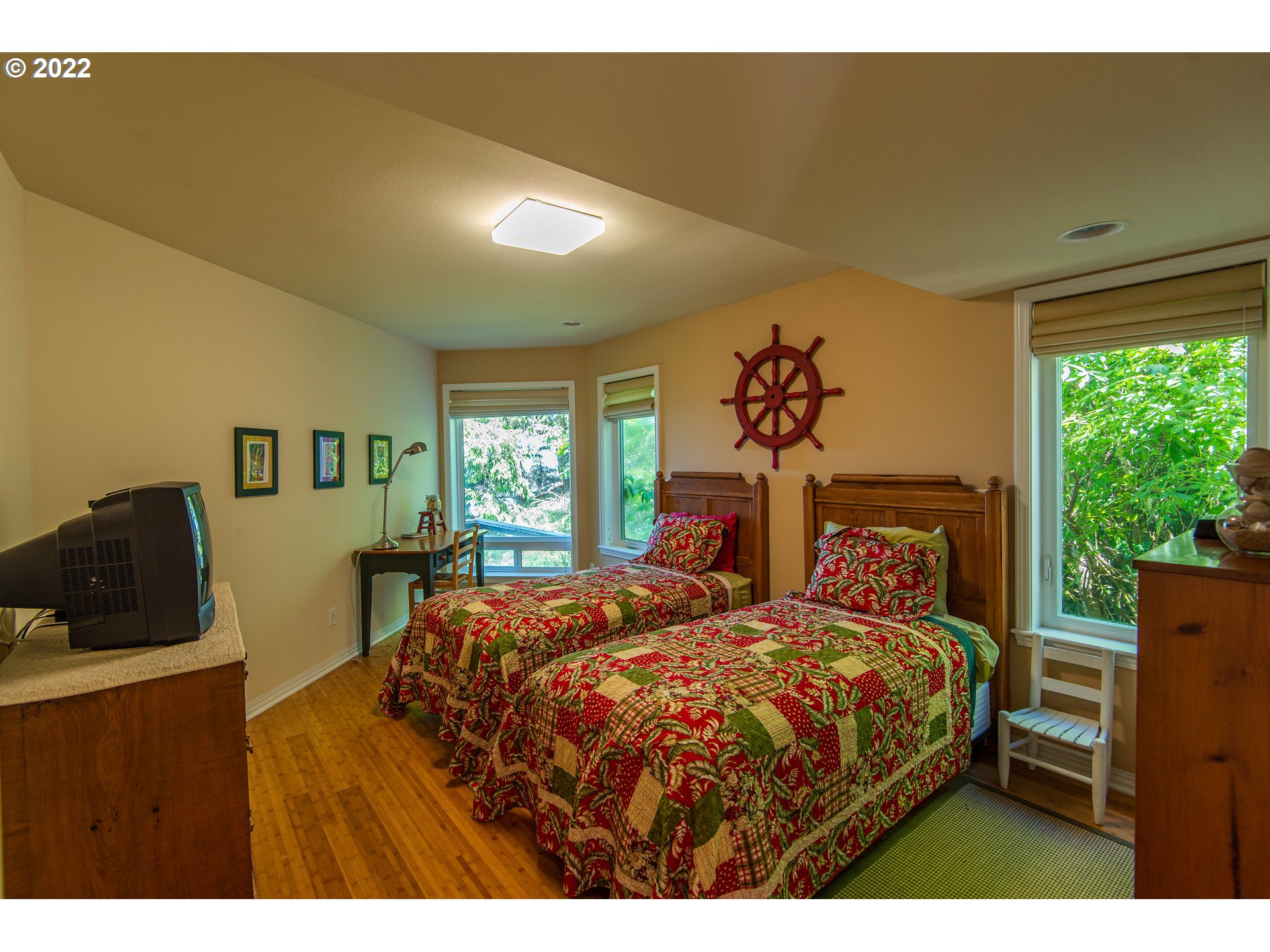 230 Crestview Drive Yachats, OR 97498 - Photo 25 of 31 a bedroom with a bed and wooden floor