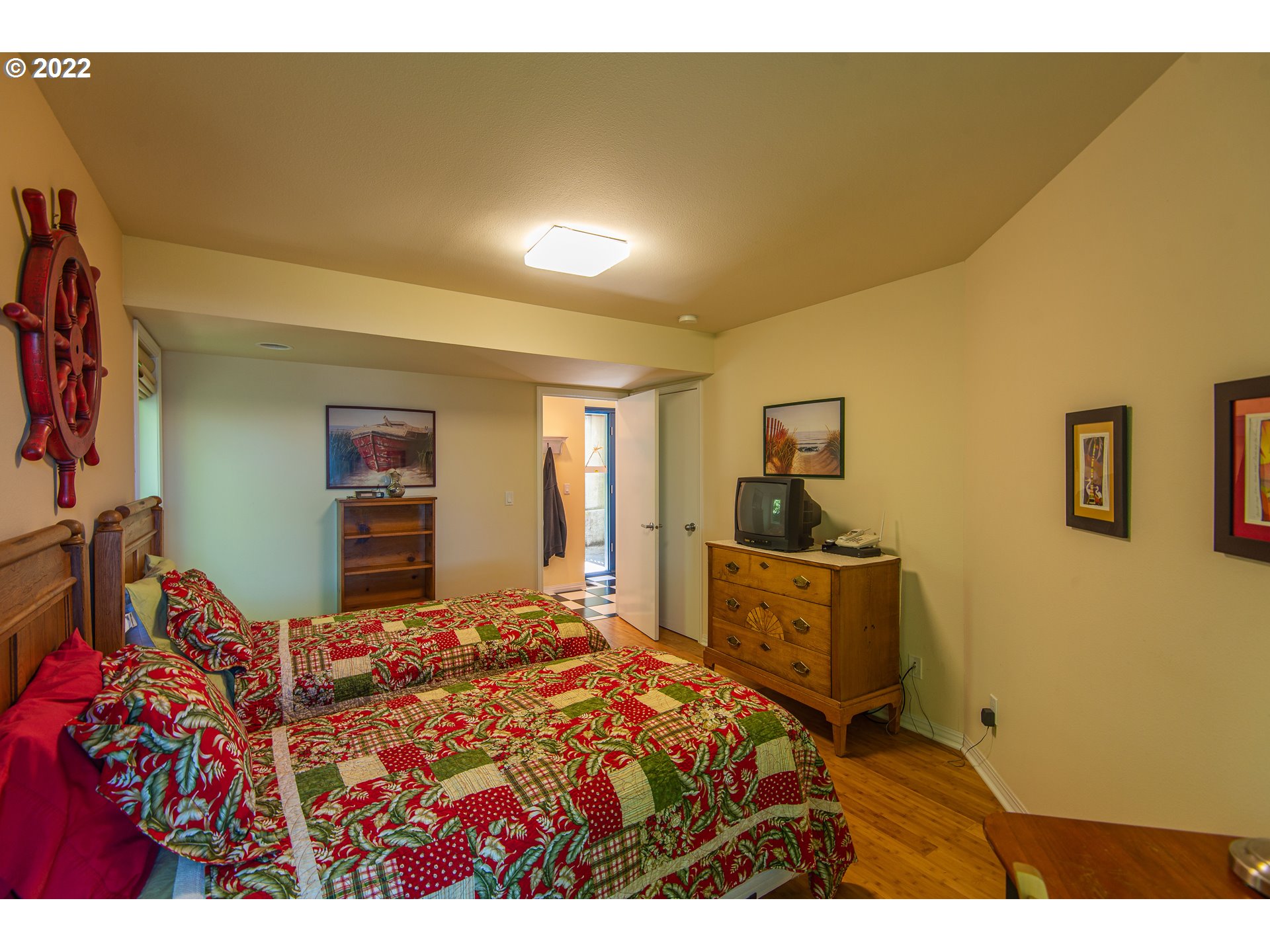 230 Crestview Drive Yachats, OR 97498 - Photo 26 of 31 a bedroom with a bed and cabinets