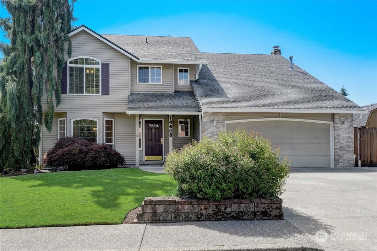 a front view of a house with a garden