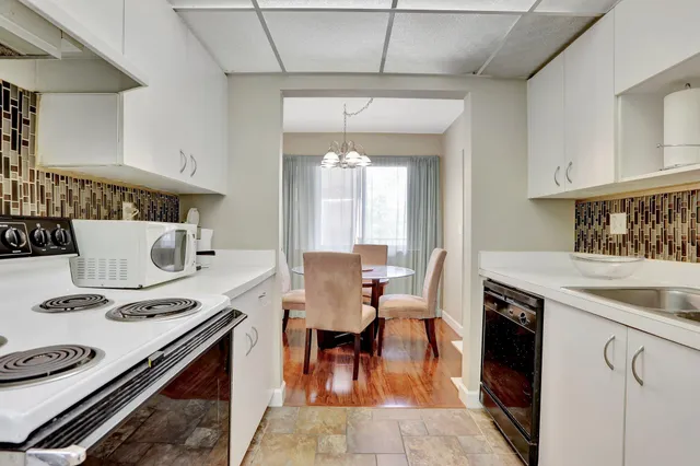 a kitchen with a stove and a dining table