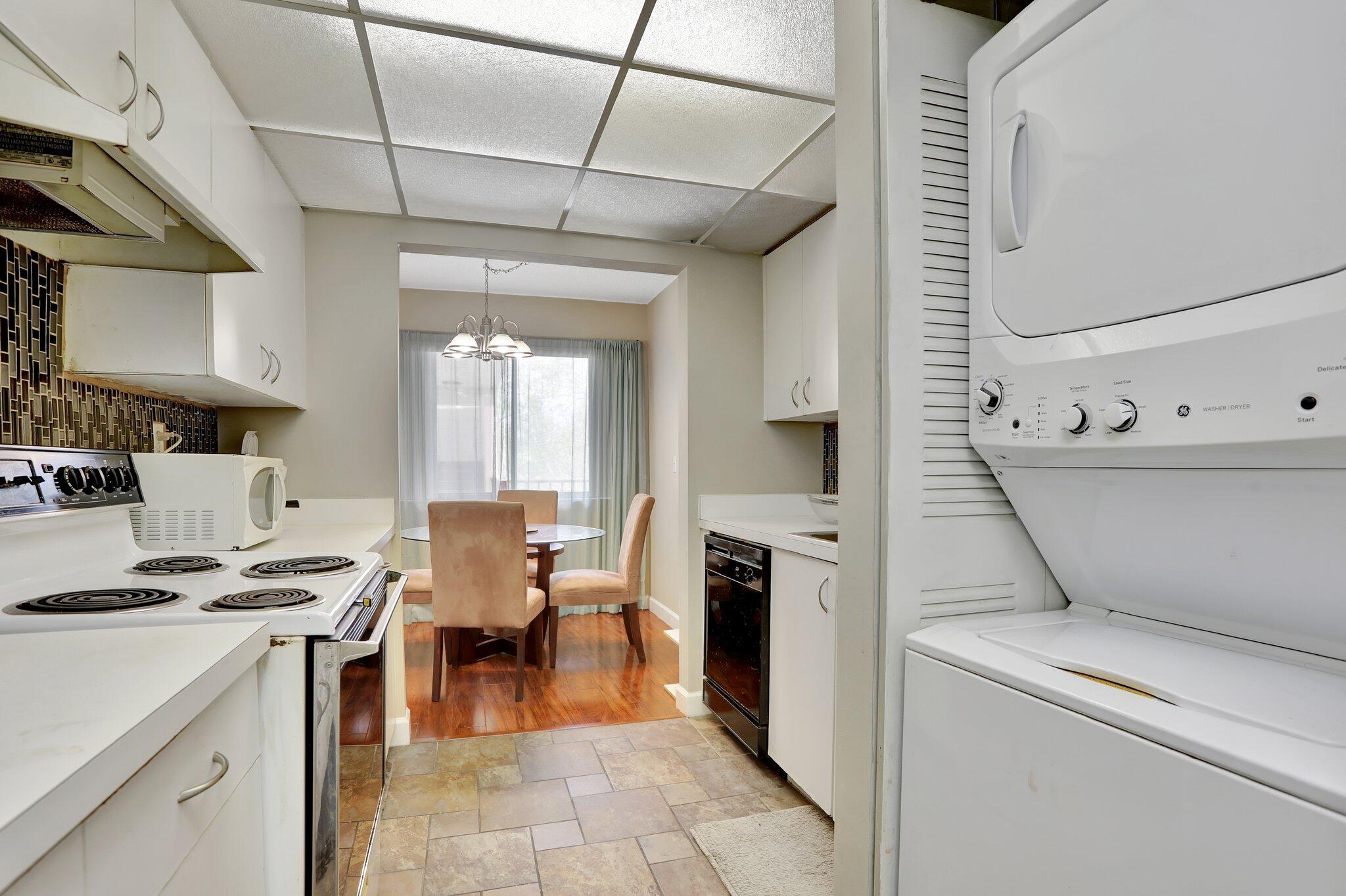 7451 Northwest 16th Street, Unit 303 Plantation, FL 33313 - Photo 12 of 41 a open kitchen that has a lot of white cabinets and stainless steel appliances