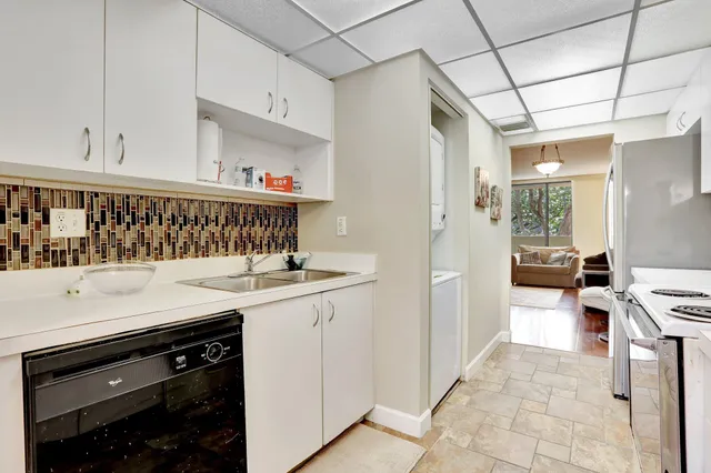 a kitchen with stainless steel appliances a stove a sink and a refrigerator