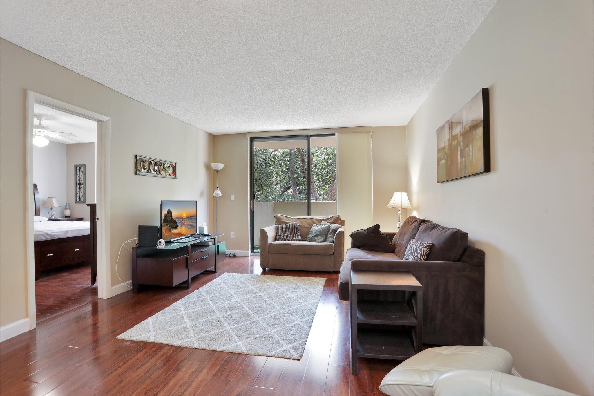 7451 Northwest 16th Street, Unit 303 Plantation, FL 33313 - Photo 16 of 41 a living room with furniture and a large window