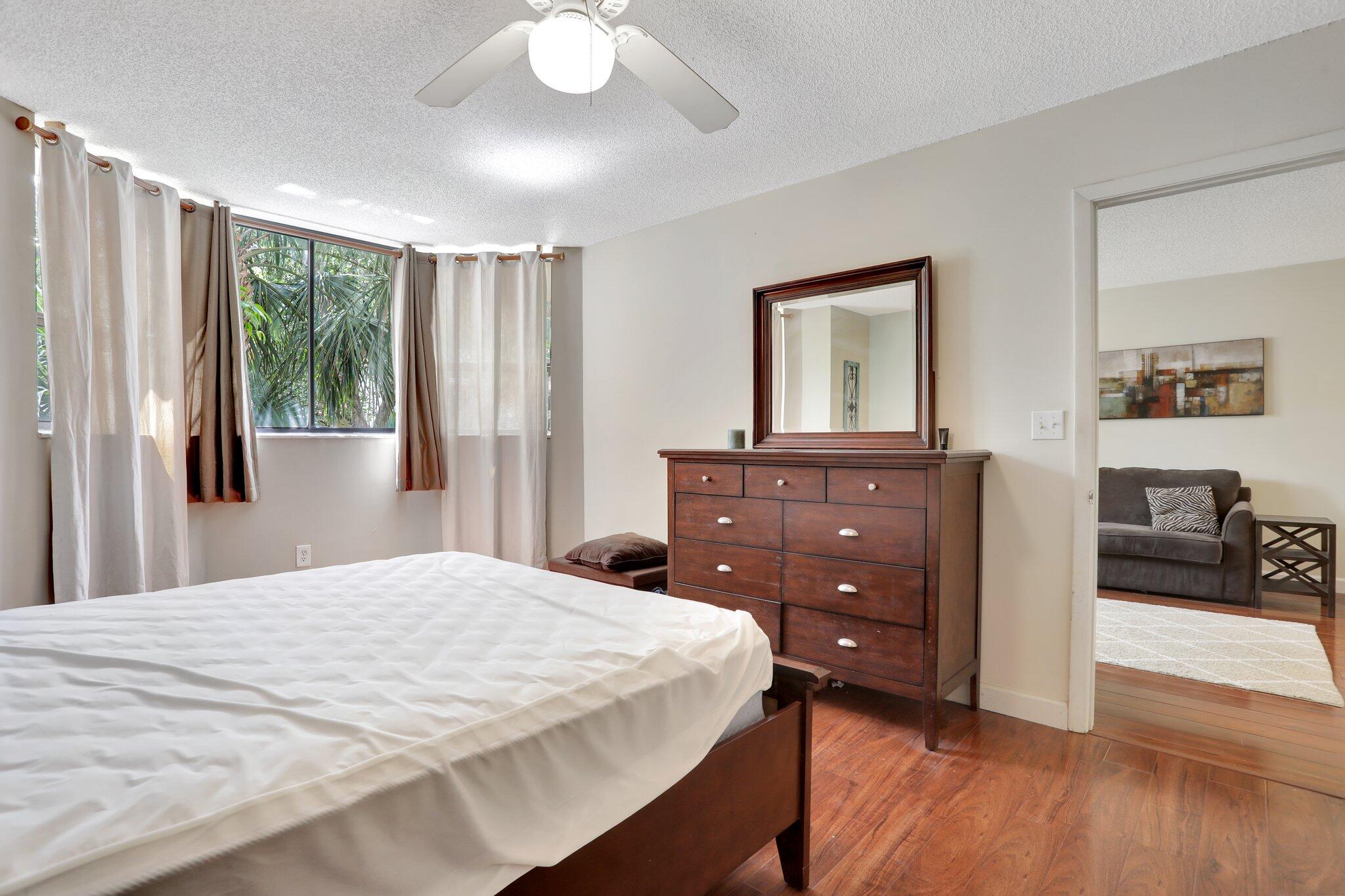 7451 Northwest 16th Street, Unit 303 Plantation, FL 33313 - Photo 21 of 41 a bedroom with a bed and a dresser