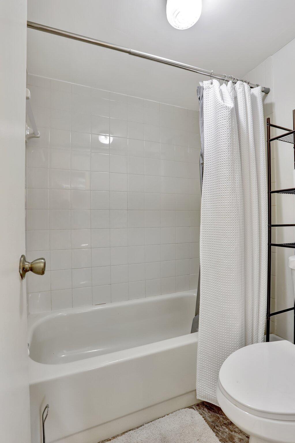 7451 Northwest 16th Street, Unit 303 Plantation, FL 33313 - Photo 25 of 41 a bathroom with a shower and a toilet