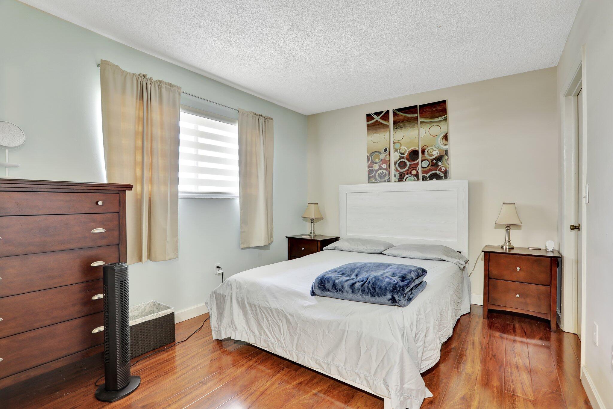 7451 Northwest 16th Street, Unit 303 Plantation, FL 33313 - Photo 7 of 41 a bedroom with a bed and a dresser