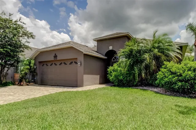 a view of a house with a yard and garage