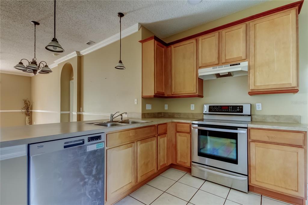 10708 Northridge Court Trinity, FL 34655 - Photo 12 of 59 a kitchen with a sink stove and microwave