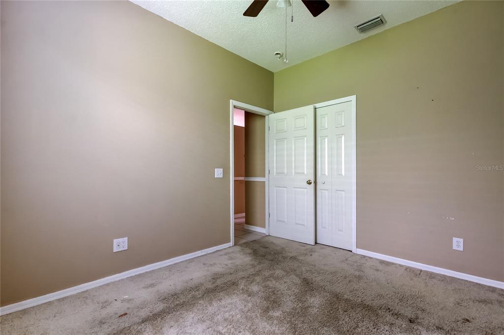 10708 Northridge Court Trinity, FL 34655 - Photo 49 of 59 an empty room with a ceiling fan and painted walls